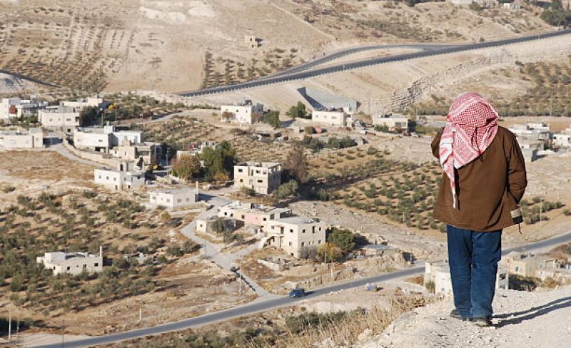 A Palestinian stands above a village on the outskirts of the West Bank town of Bethlehem.