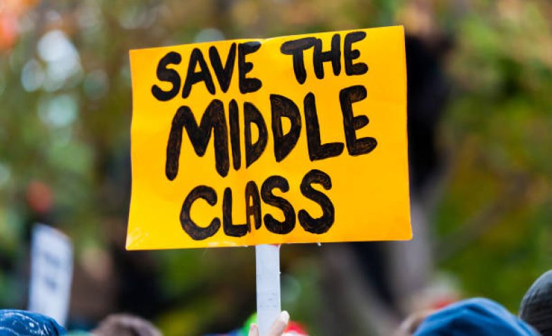 A protest sign reading "Save the Middle Class".
